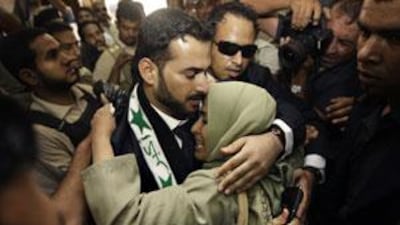 Muntazer al Zaidi embraces his sister at Al-Baghdadia television station following his release from prison yesterday.