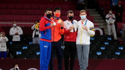 From left, silver medalist Saeid Mollaei of Mongolia, gold medalist Takanori Nagase of Japan, bronze medalists Shamil Borchashvili of Austria and Matthias Casse of Belgium celebrate with their medals during the award ceremony for the men -81kg judo match.