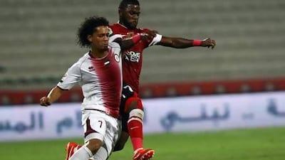Al Wahda’s Mohamed Al Shehhi, left, tries keeping Ismail Al Hammadi of Al Ahli off the ball.