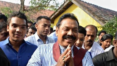 Sri Lanka's President Mahinda Rajapaksa gestures outside a polling station in his home town of Tangalla, on January 8, 2015. AFP PHOTO / LAKRUWAN WANNIARACHCHI