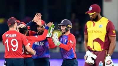 England's players celebrate after the dismissal of West Indies' Andre Russell. AFP
