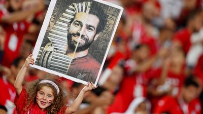 A young Egypt fan holds up a picture of Egypt's Mohamed Salah before the 2019 Africa Cup of Nations match against Uganda at the Cairo International Stadium in Cairo. Salah had been criticised in his homeland for defending teammate Amr Warda's expulsion from the squad over allegations of sexual harassment. Reuters