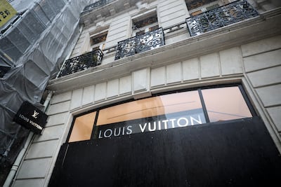 A vandalised Louis Vuitton luxury shop with its broken windows boarded up in Marseille. Reuters