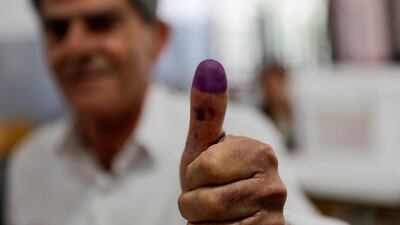 A Lebanese man showcases his ink-stained thumb after casting his vote in the first Lebanese parliamentary election in nine years, in the coastal city of Byblos, north of the capital Beirut. Joseph Eid / AFP