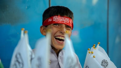 An Afghan boy sells flags of the Islamic Emirate of Afghanistan on August 13, 2026, ahead of the fifth anniversary of the Taliban's return to power. EPA
