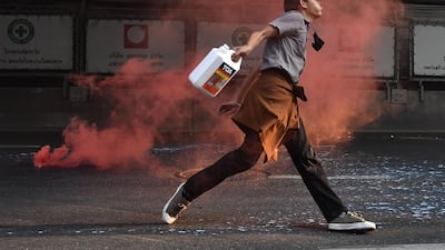 A Thai pro-democracy protestor confronts riot police in Bangkok, in the area where Myanmar migrants were demonstrating after Myanmar's military detained the country's de facto leader Aung San Suu Kyi and the country's president in a coup. AFP