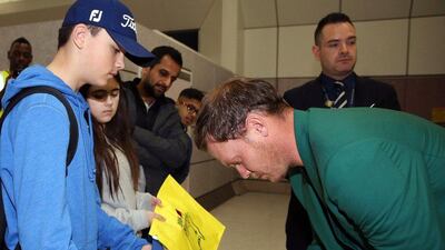 Britain's Danny Willett signs an autographs as he arrives at Manchester Airport, England, Tuesday April 12, 2016, after his victory at the Masters on Sunday. Willett arrived back in Britain having become the first European to win the Masters since 1999 and only the second English player to receive the green jacket. (Martin Rickett/PA via AP)