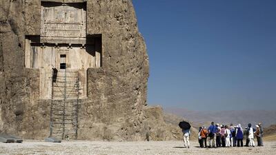 A group of German tourists visit the tomb of Achaemenid emperor Darius I the Great at Naqsh-e Rostam necropolis, located about 12km northwest of Persepolis, near Shiraz in southern Iran. Behrouz Mehri / AFP