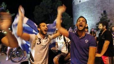 Greek fans celebrate in downtown Thessaloniki after a defensive Greece held off a nearly non-stop Russian attack on Saturday.