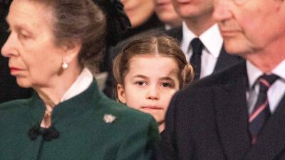 Princess Charlotte sits behind Princess Royal, Anne, and Vice Admiral Timothy Laurence during a Service of Thanksgiving for Britain's Prince Philip, at Westminster Abbey in March 2022. AFP