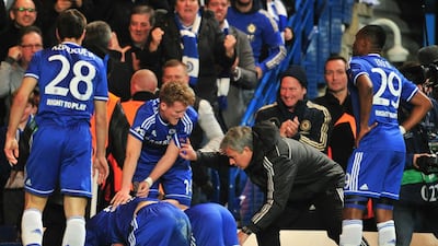 Chelsea's Portuguese manager Jose Mourinho talks to his players as they celebrate their second goal scored by Demba Ba at Stamford Bridge on Tuesday. Glyn Kirk / AFP / April 8, 2014