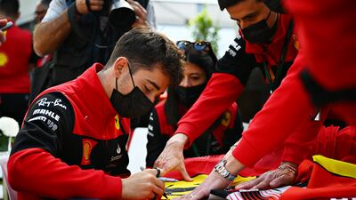 Charles Leclerc signs autographs for fans in the paddock during previews ahead of the F1 Grand Prix of Australia. Getty