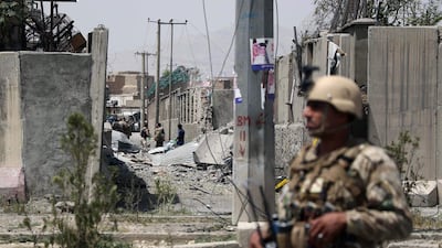 An Afghan security personnel stands guard at the site where a Taliban car bomb detonated at the entrance of a police station in Kabul. Scores of people were wounded. AFP