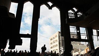 Palestinians look at the destroyed al Kolafa mosque after an Israeli air strike.