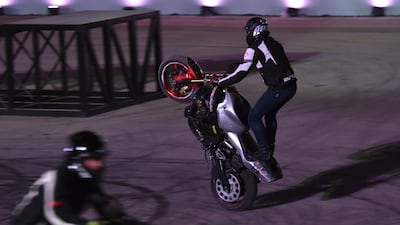 Members of the US Police Academy perform motorbike stunts at the Riyadh Motor Show at Al-Janadriyah village in the Saudi capital. AFP