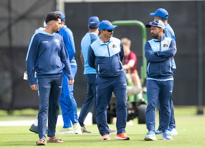 Coach Lalchand Rajput, centre, chats as the teams wait for the field to dry ahead of UAE's abandoned ODI against Canada in Dundee.