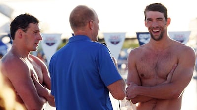 US swimmer and Olympic medalist Michael Phelps, right, answers questions during a post-race interview with former US swimmer Rowdy Gaines, centre, as US swimmer Ryan Lochte, left, looks on, following the finals of the Men's 100 Meter Butterfly, at the 2014 USA Swimming Grand Prix Series in Mesa, Arizona, USA, 24 April 2014. Lochte won the event with Phelps finishing second. EPA/ROY DABNER