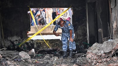 A member of the Bangladeshi Air Force inspects the scene a day after a training jet crashed into a school in Dhaka. AFP