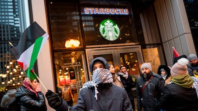 Pro-Palestine activists protest against Starbucks in the US city of Chicago. Reuters