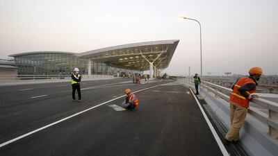 Workers paint on traffic lanes at the new terminal of Noi Bai international airport in Hanoi. Flag carrier Vietnam Airlines became the first airline to use the terminal for its Flight VN661 from Hanoi to Singapore on Christmas day. Kham / Reuters