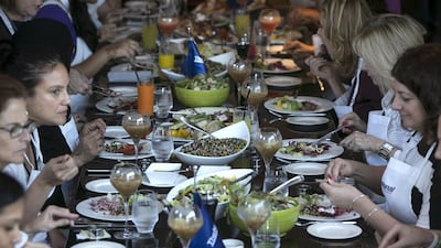 Guests and The National staff enjoy the food and the company after a morning spent cooking at the #healthyliving cooking experience. Silvia Razgova / The National