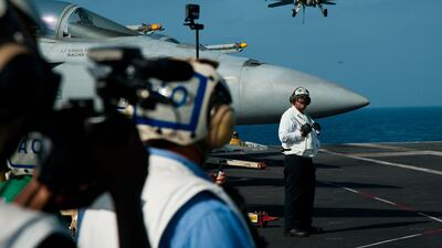 An F/A-18 fighter jet lands on the deck of the USS Abraham Lincoln aircraft carrier. AP