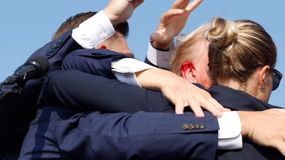 Blood can be seen on Trump's head after shots were heard. AFP