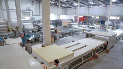 A mattress gets moved on a hightech conveyor belt to the next stage of production. Workers used to have to carry each mattress to the next area in the “old days” of production. Victor Besa for The National