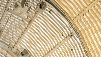 Construction workers clean the seats inside the Lusail Stadium. The stadium will host 10 games including the final of the 2022 World Cup. Getty
