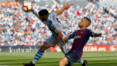 Real Sociedad's Joseba Zaldua leaps for the ball ahead of Barcelona's Jordi Alba. Reuters