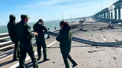 Members of Russia's investigative committee on the Kerch bridge near the site of the blast. AP
