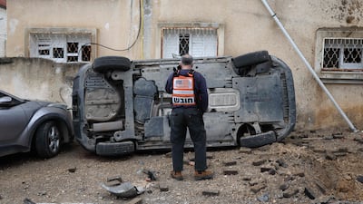 A man surveys the damage after a missile strike in the mainly Arab city of Kfar Qassem, Israel. AFP