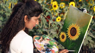 An artist is inspired by the flowers on display