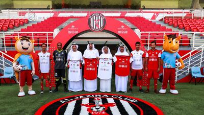 Al Jazira FC will wear the new Special Olympics football jersey for the first time on August 31, 2018. From left to right: Ahmed Al Gilani, Special Olympics athlete; Al Jazira striker Ali Mabkhout Al Hajeri; Dr Yousef Al Hammadi, Chief Intelligence Officer for the Special Olympics; Homaid Al Shimmari, Deputy Group CEO for Mubadala; Mohammed Saif Al Suwaidi, Chairman of Al Jazira Football Sport Company; Talal Al Hashemi, National Director, Special Olympics UAE; Abdul Rahman Al Gilani, Special Olympics athlete; and Al Jazira goalkeeper Ali Kaseif Al Hosani. Victor Besa / The National