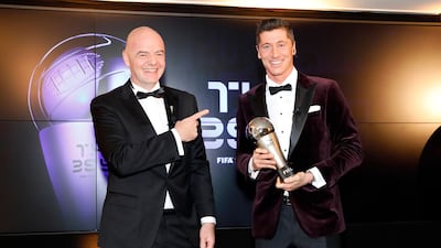 Bayern Munich's Robert Lewandowski receives the the men's player of the year trophy from Gianni Infantino during Fifa The BEST Awards ceremony in Munich. Getty