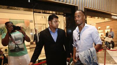 Chelsea's Didier Drogba, right, walks the red carpet at the Vogue Cafe launch party at Dubai Mall in Dubai, May 29, 2013. Sarah Dea/The National