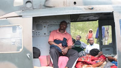 Injured people rest in a helicopter in Chimanimani. EPA