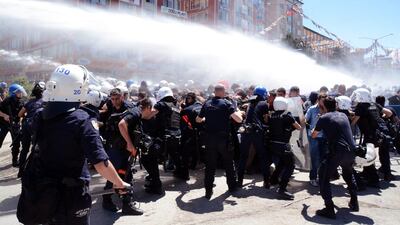 Turkish riot police use water cannon as they try to protect people from a group of people of unknown affiliation who were attacking a rally of pro-Kurdish Peoples' Democracy Party, (HDP) in eastern city of Erzurum, Turkey, on June 4. AP