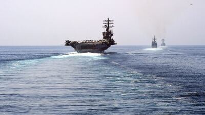 A US aircraft carrier passes the Strait of Hormuz. Any attempt to close the waterway would risk a major confrontation with the US. AFP