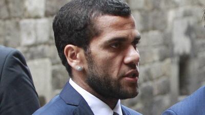 Dani Alves picked up a banana thrown at him during Barcelona's game against Villarreal on Sunday and ate it in defiance. Marta Perez / EPA