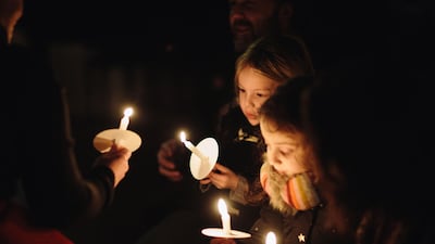 Candles are lit during the Singing for Syrians Carol Service in St Margaret’s Church, Westminster, in 2018. Courtesy Hands Up Foundation