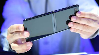 A member of the media holds a Samsung Galaxy Z Flip. AFP