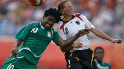 Rita Chikwelu, left, of Nigeria and Kerstin Stegemann of Germany battle for the ball.