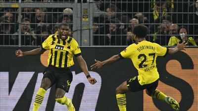 Dortmund's French forward Anthony Modeste (L) celebrates his 2-2 during the German first division Bundesliga football match between BVB Borussia Dortmund and FC Bayern Munich in Dortmund, western Germany, on October 8, 2022. (Photo by INA FASSBENDER / AFP) / DFL REGULATIONS PROHIBIT ANY USE OF PHOTOGRAPHS AS IMAGE SEQUENCES AND / OR QUASI-VIDEO