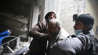 Abu Mohammed Alaya, 50, is helped out from shelter in Douma, Syria on February 22, 2018. Bassam Khabieh / Reuters