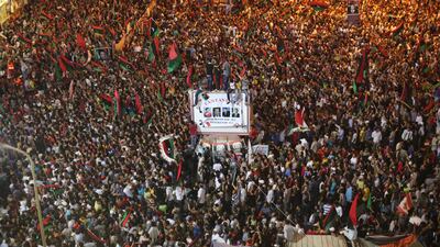 People celebrate the capture in Tripoli of Moammar Gadhafi's son and one-time heir apparent, Seif al-Islam, at the rebel-held town of Benghazi, Libya, early Monday, Aug. 22, 2011. Libyan rebels raced into Tripoli in a lightning advance Sunday that met lit???