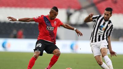 Ciel of Al Ahli, left, takes on Ali Mabkhout of Al Jazira during their Arabian Gulf League football match at Mohammed bin Zayed Stadium, Abu Dhabi. 10 April 2016. Adil Alnaimi / Al Ittihad