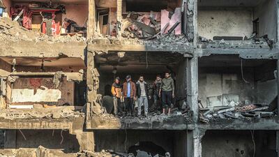 Palestinians check a half-destroyed building after an Israeli bombardment on Rafah, in the southern Gaza Strip. AFP
