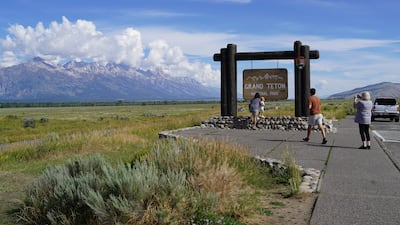 People take pictures at Grand Teton National Park, outside Jackson. Willy Lowry / The National