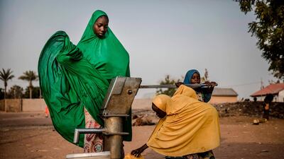 Camp dwellers pump water from a well at Malkohi refugee camp in Jimeta, Adamawa State, Nigeria. AFP